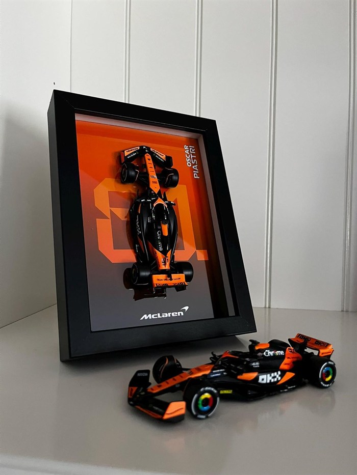 Framed McLaren artwork beside a 3D-printed Formula 1 car model.